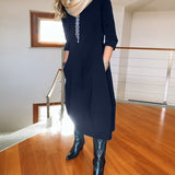 Robe élégante de couleur unie avec poche et col rond