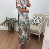 Robe élégante torsadée à col en V et imprimé botanique